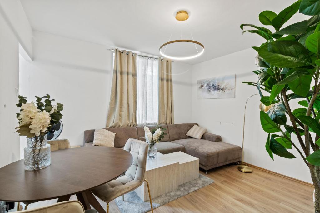 a living room with a couch and a table at Stylish Flat, next to Handelskai in Vienna