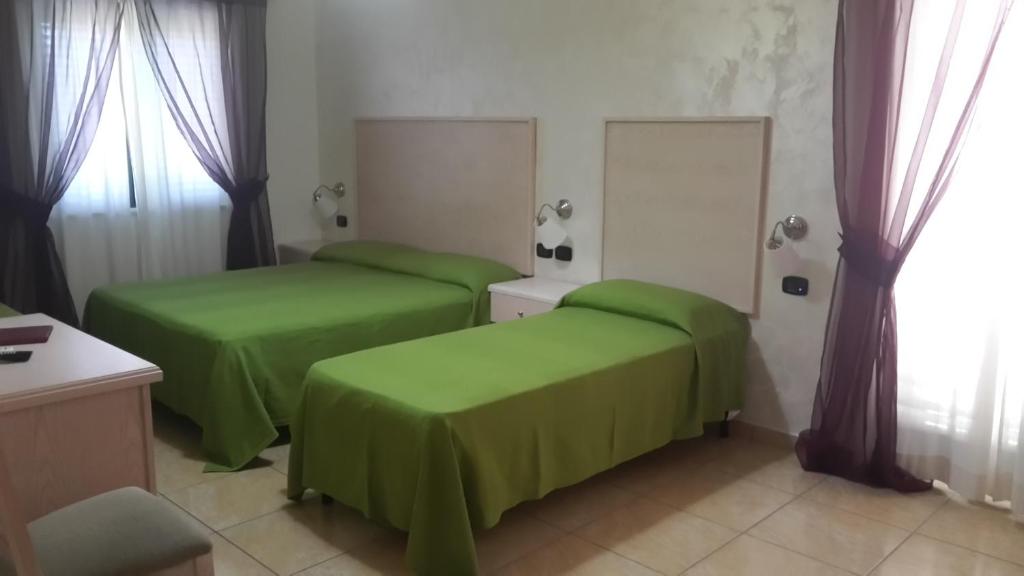 Postel nebo postele na pokoji v ubytování Hotel Miramare