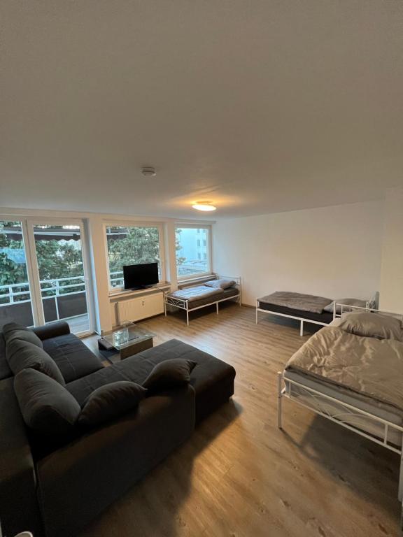 a living room with a couch and a bed at Unterkunft NRW ID1 in Leverkusen