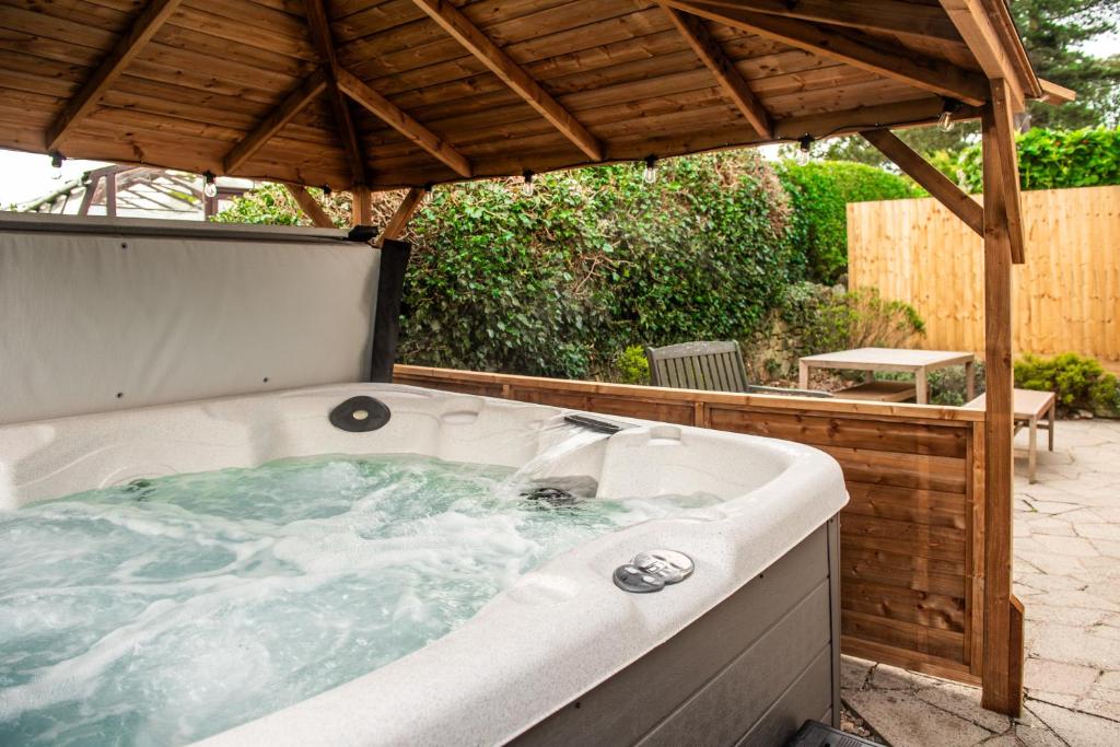 a hot tub under a gazebo at Stag Manor Hot Tub Retreat near Peak District in Crich