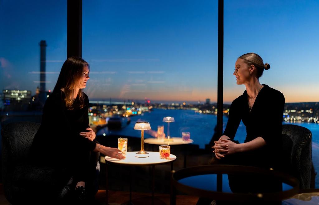 two women sitting at a table in a restaurant at Hotel Riverton in Gothenburg