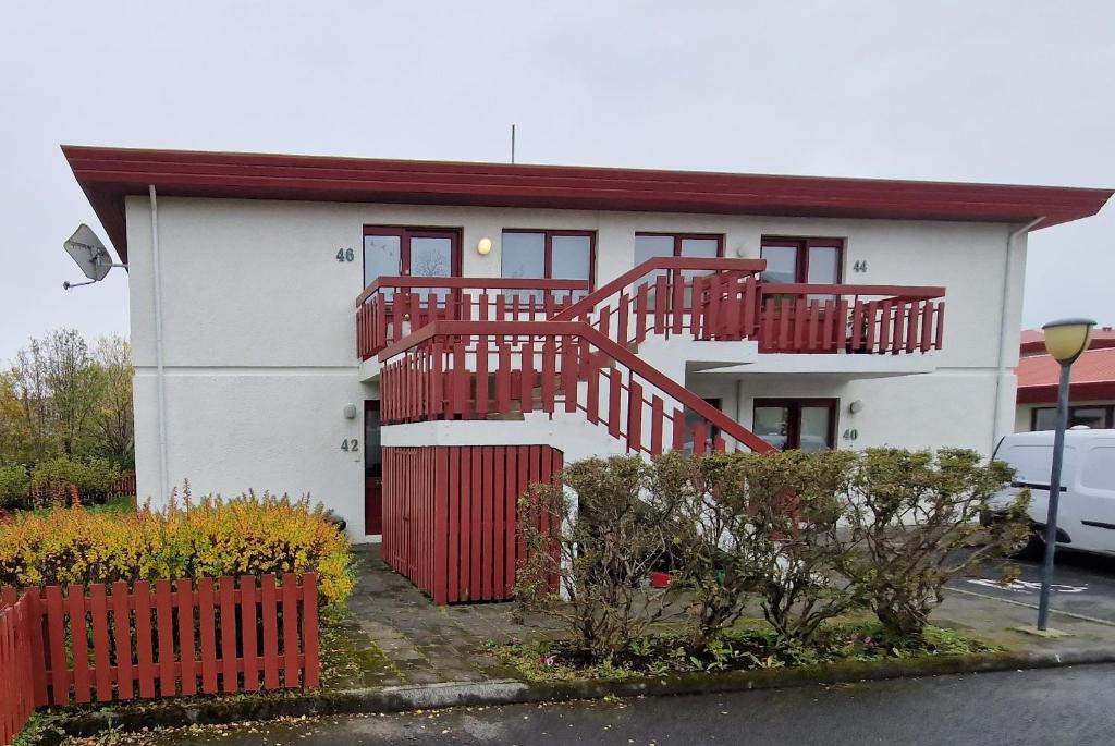 une maison avec un escalier rouge devant elle dans l'établissement Reykjavikurvegur 42, à Reykjavik