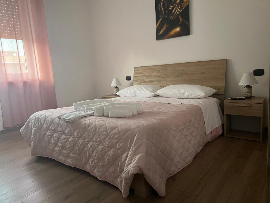 a bedroom with a large bed with two pillows at Stanza Georgina in Verona