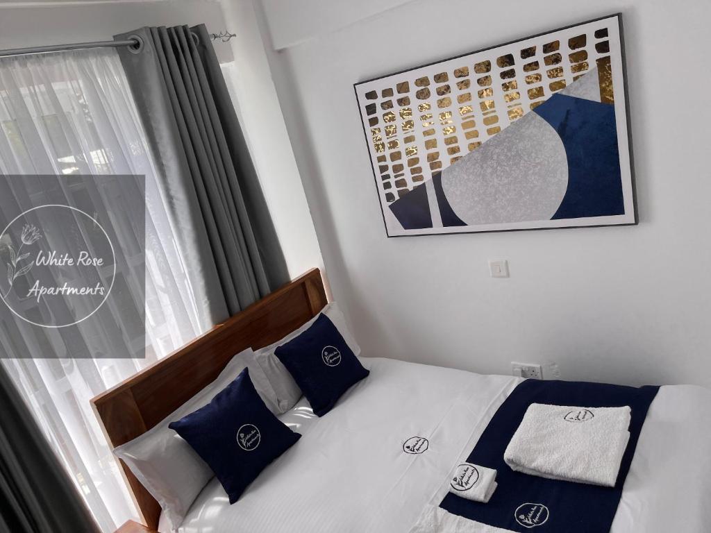Postel nebo postele na pokoji v ubytování WhiteRose Apartments