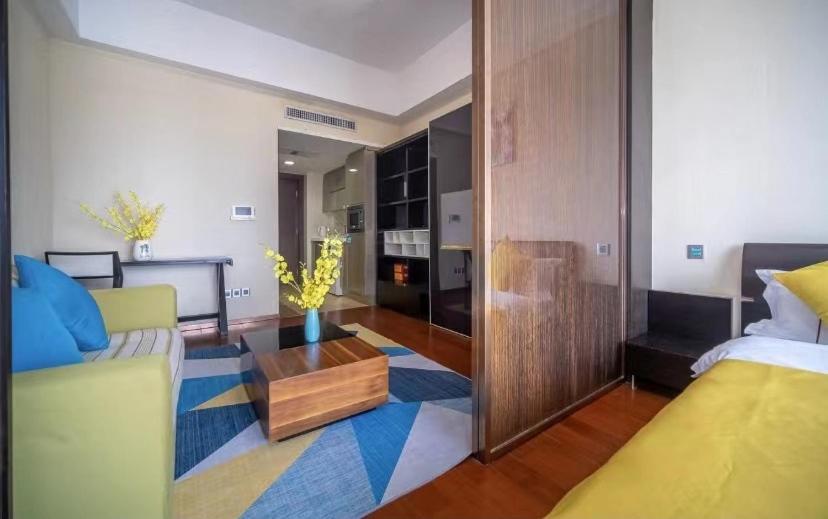 a living room with a bed and a couch at Manriver Executive Apartments in Guangzhou