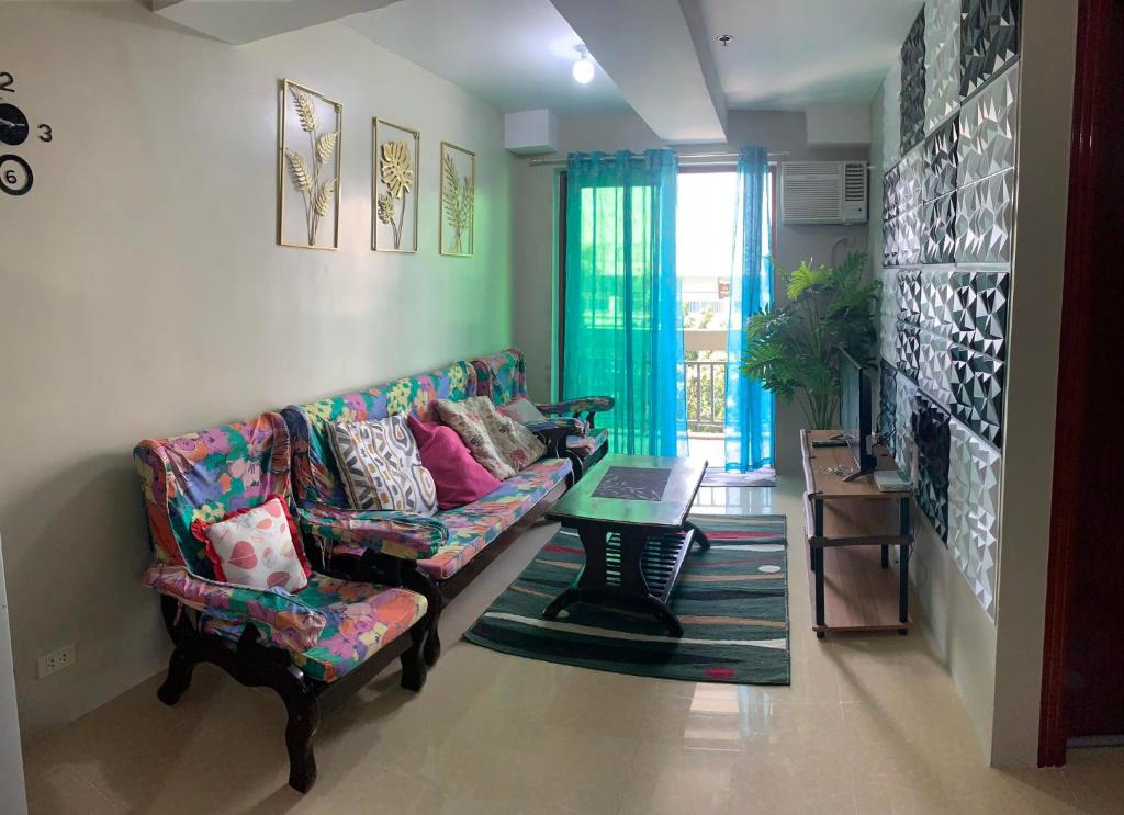 a living room with a couch and a table at Mmr in Manila