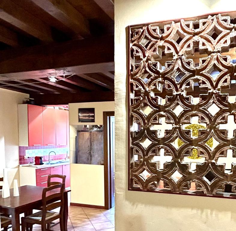a kitchen and a dining room with a wall art at Residenza dei Mille in Mantova
