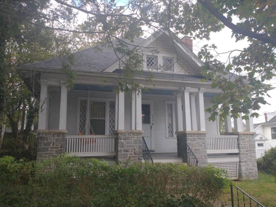 a small white house with a porch and columns at Blackjack's Bungalow in York