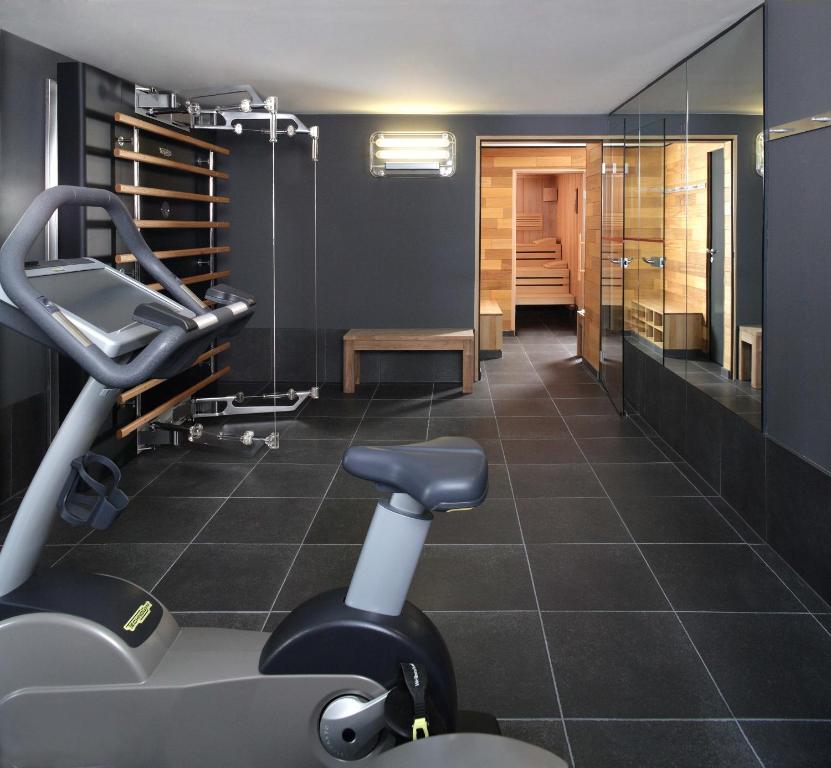 a gym with a treadmill and a chair in a room at Casa Camper Berlin in Berlin