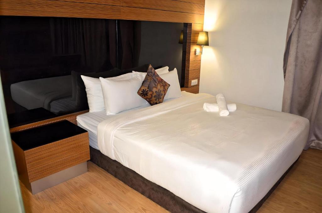 a bedroom with a large white bed in a room at Royal Suites At Dua Sentral in Kuala Lumpur
