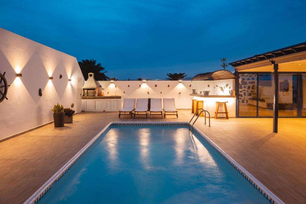 a swimming pool in the backyard of a house at Casa Melián in Playa Blanca