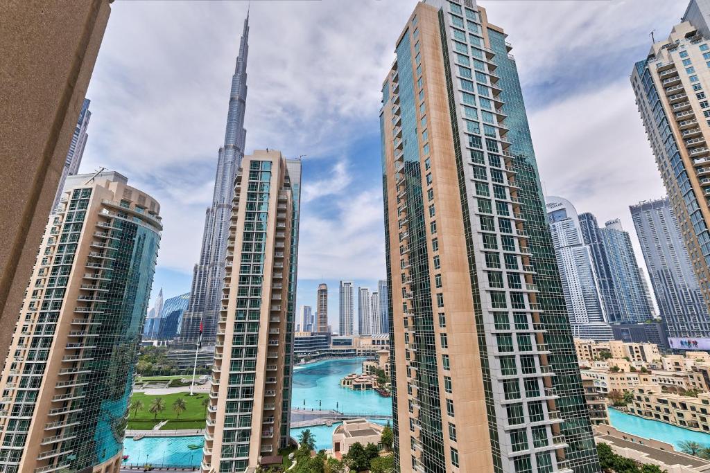 a view of a city with tall buildings at BellaVista Boulevard Central Spacious 2 Bedroom with maids room Burj Khalifa and Fountain View in Dubai