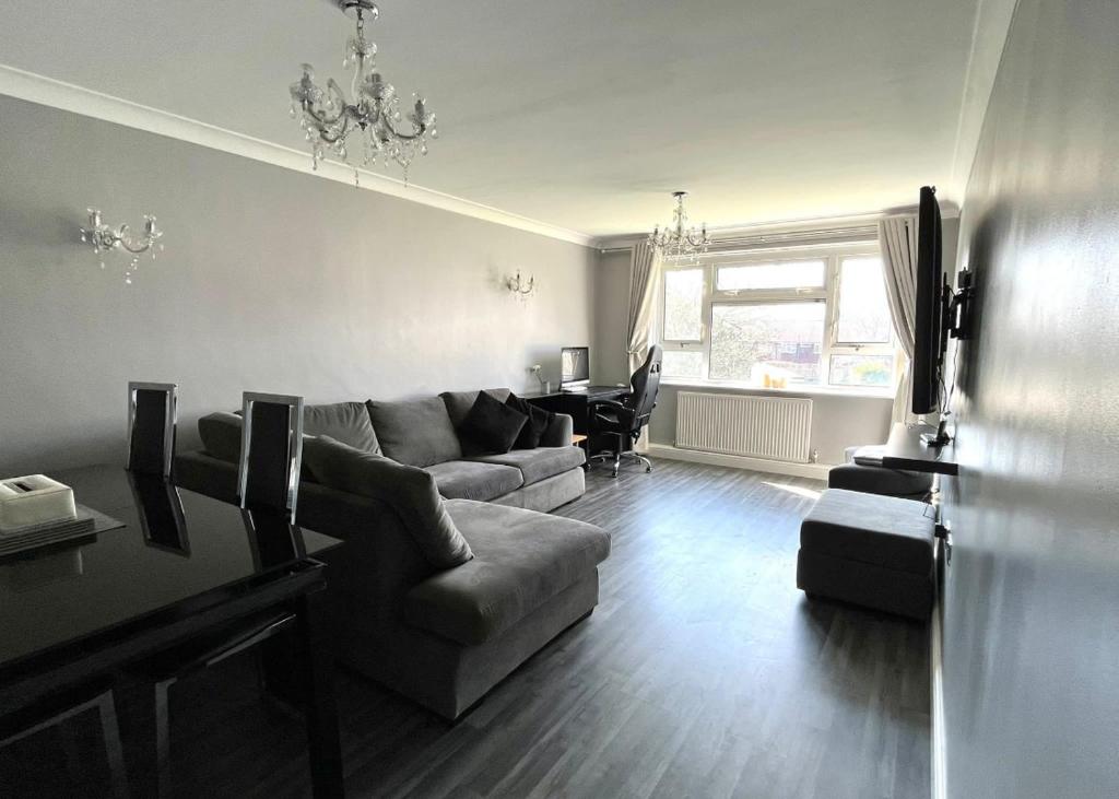 a living room with a couch and a table at Modern Stylish Two Bedroom Apartment in Beckenham