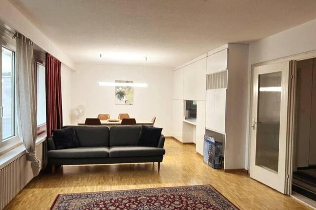a living room with a couch and a table at Cosy 4.5 rooms apartment @ LS 16 Dübendorf in Dübendorf