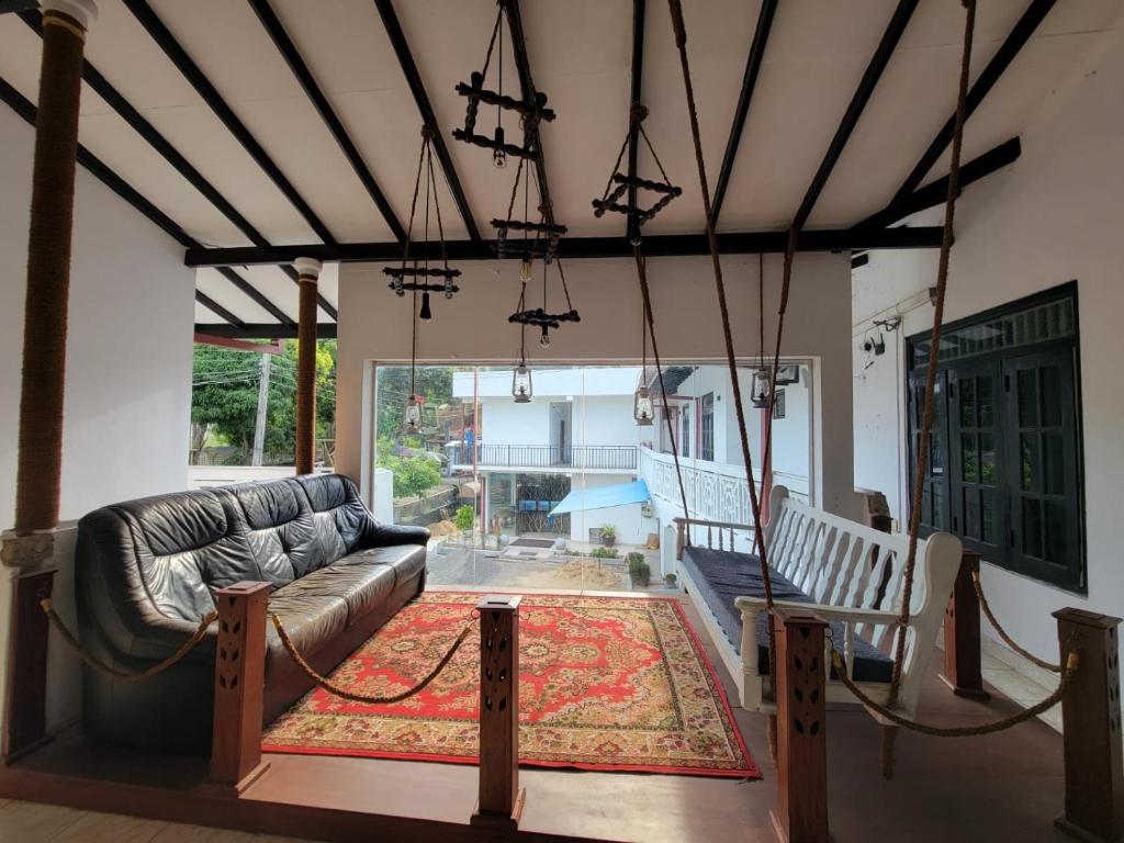 a living room with a couch and a rug at The Empyrean Airport Transit Hotel in Katunayake