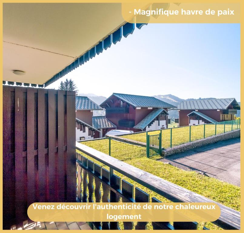 a view of a village with houses and a fence at Appartement I Sublime I Les Gets in Les Gets