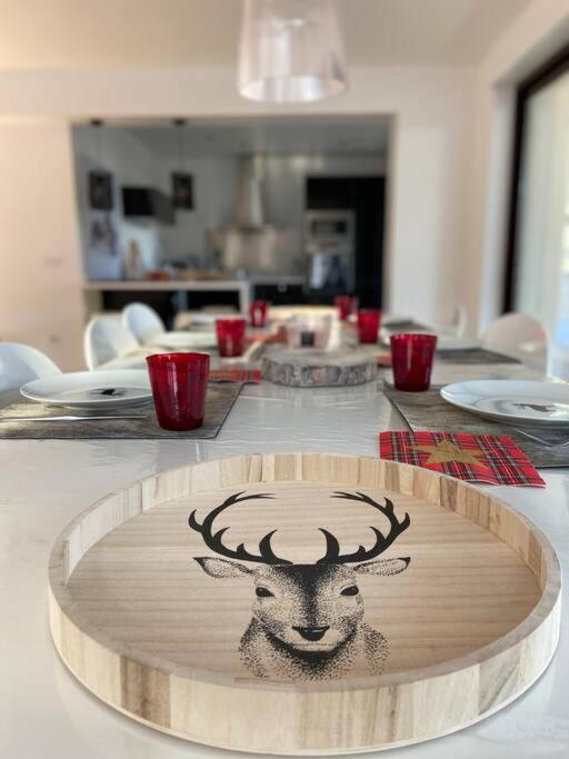 a table with a plate with a picture of a deer on it at L'Etoile de la Forêt in Bolquere Pyrenees 2000