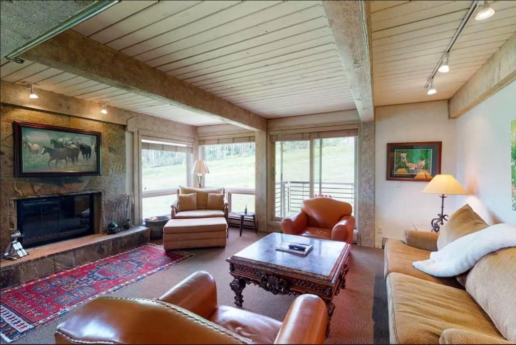 a living room with leather furniture and a fireplace at Enclave 201, Snowmass Ski-In/Ski-Out Condo w/Shared Pool/Hot Tub/Gym/WiFi in Snowmass Village