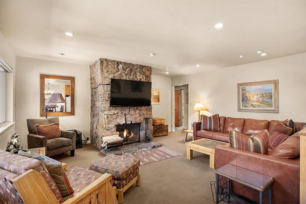 a living room with a couch and a fireplace at Silverglo Condominiums Unit 308, Expansive 4 BD Condo, Walking Distance to Town with Pool Access in Aspen