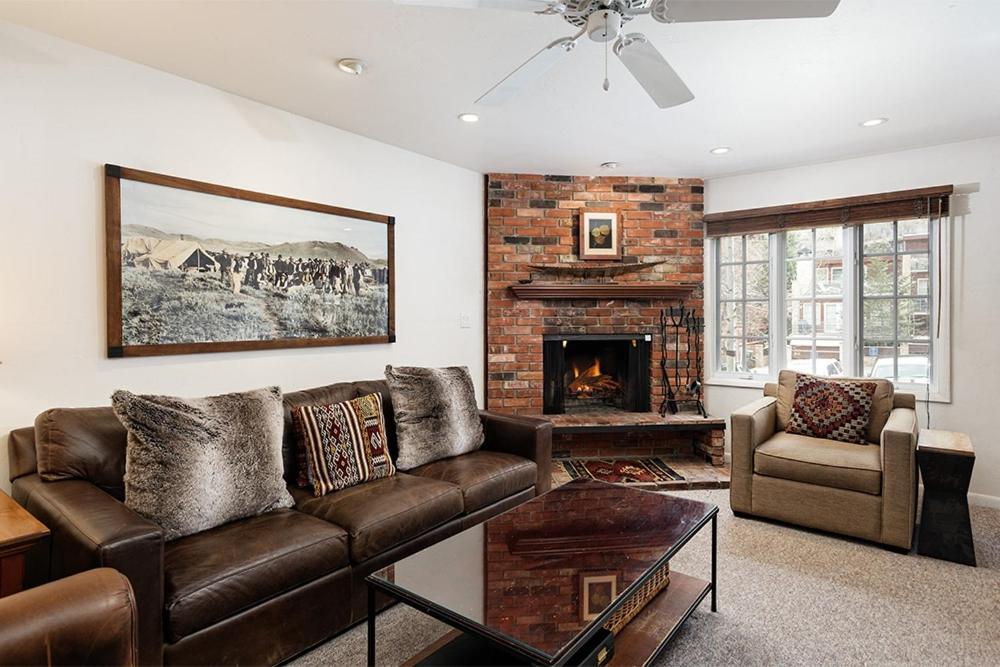 a living room with a couch and a fireplace at Alpenblick Unit 18, Spacious Remodeled Townhouse with Great Location in Aspen