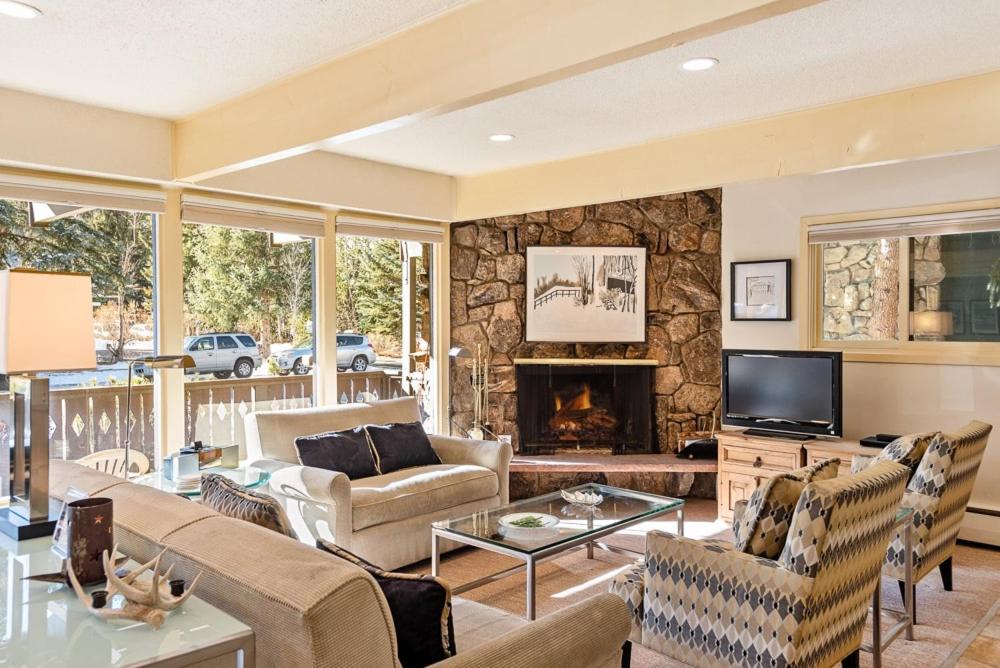 a living room with a couch and a fireplace at 118 E. Bleeker Street Lower Level, Large Lower-Level Condo in Duplex with Private Deck in Aspen