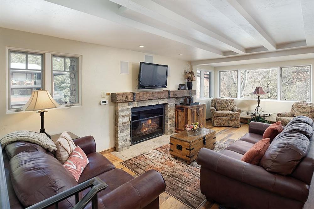 a living room with two couches and a fireplace at Fasching Haus Unit 8, Deluxe Condo w/ A/C, Private Deck, 2 Blocks to Downtown in Aspen