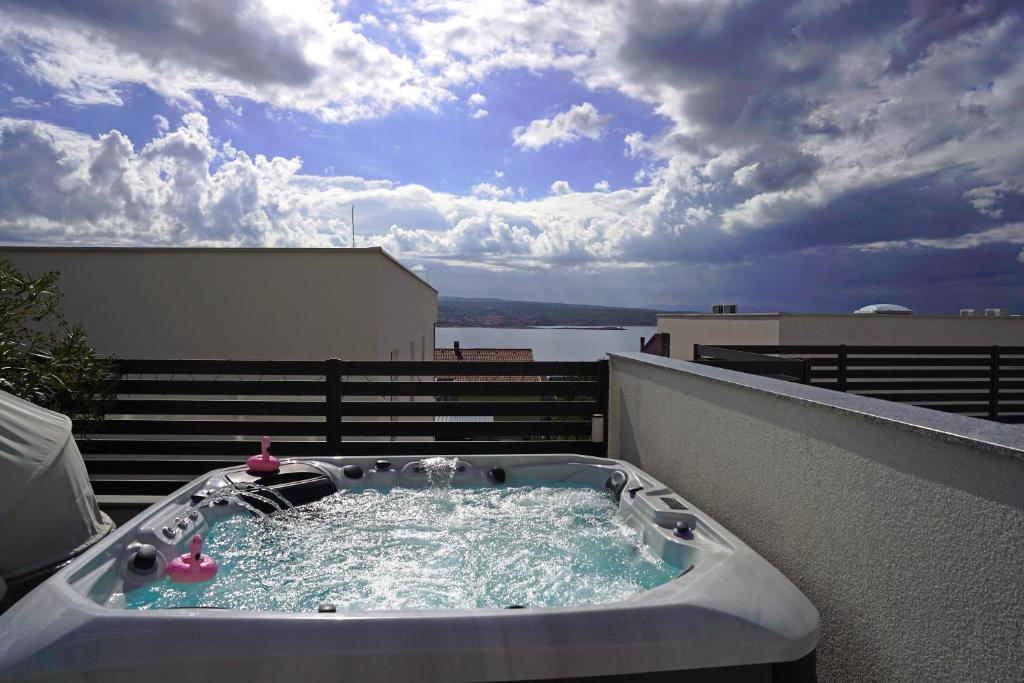 a hot tub on top of a balcony at Sobol Apartments 'Navis' with private jacuzzi in Crikvenica