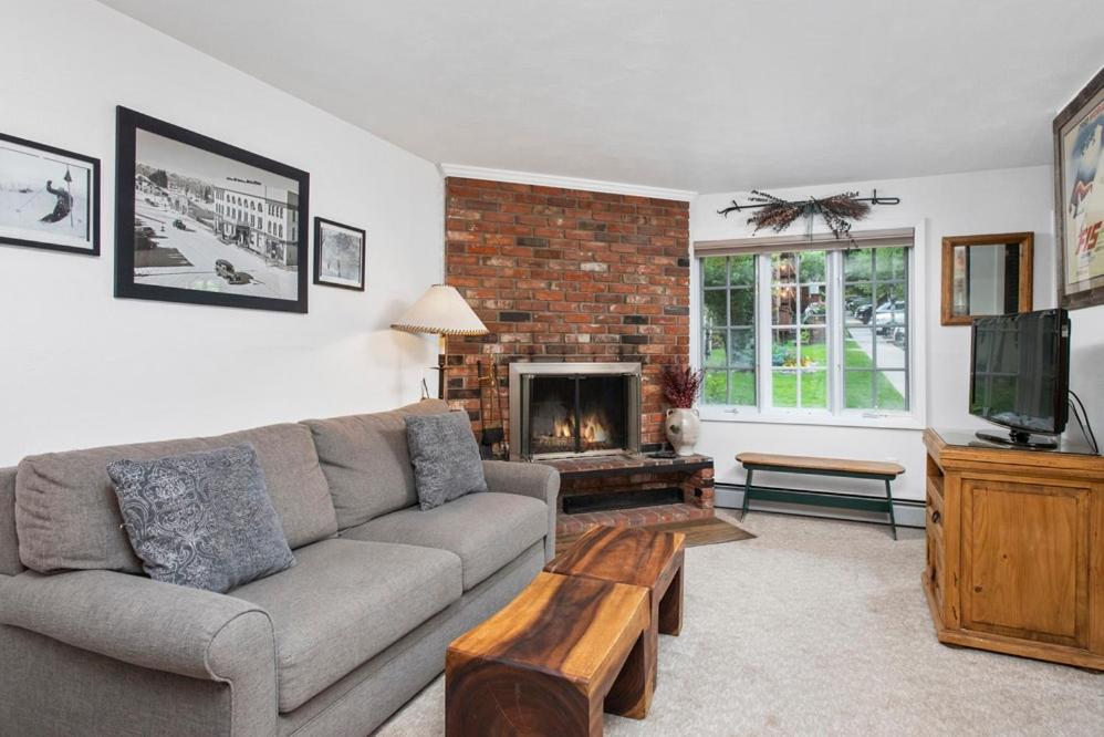 a living room with a couch and a fireplace at Alpenblick 1, Three Level Townhouse with Fireplace, Private Balcony, and Great Location in Aspen