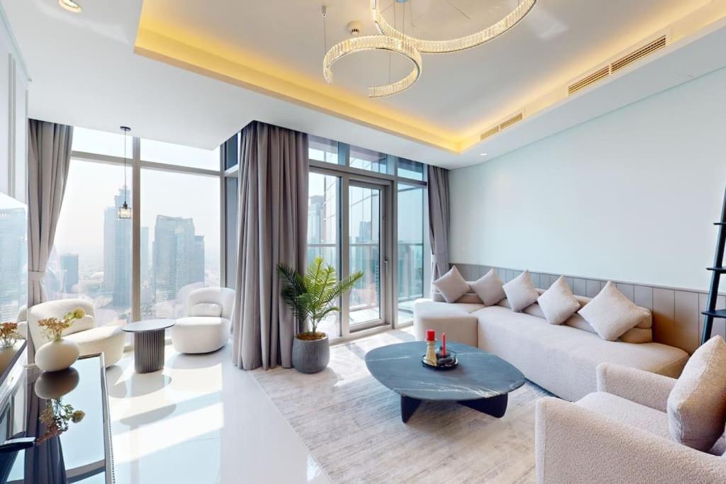 a living room with a couch and a table at Paramount, Midtown - Locations in Dubai