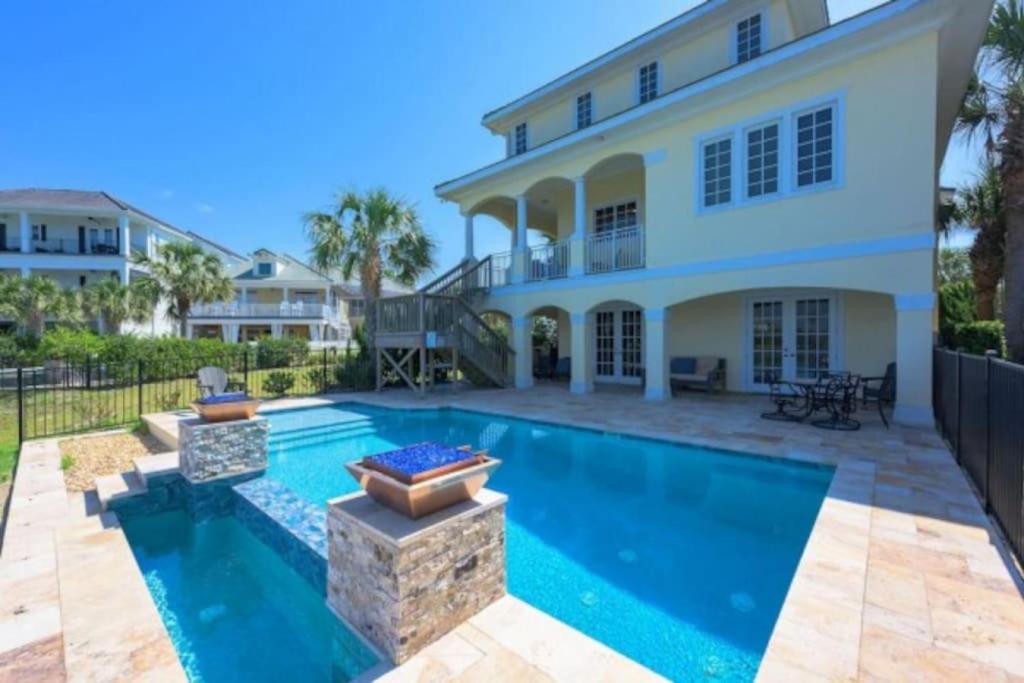 a swimming pool in front of a house at New Beachcombers at Luxurious Cinnamon Cove with Pool in Palm Coast
