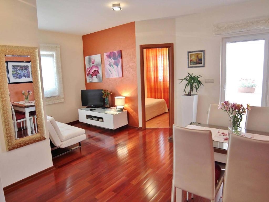 a living room with a dining table and a living room with at Apartment Gaga in Rovinj
