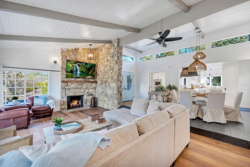 a living room with a couch and a fireplace at Modern Family Farmhouse with Pool, Jacuzzi, Putting Green, Treehouse, Bocce and more in Thousand Oaks