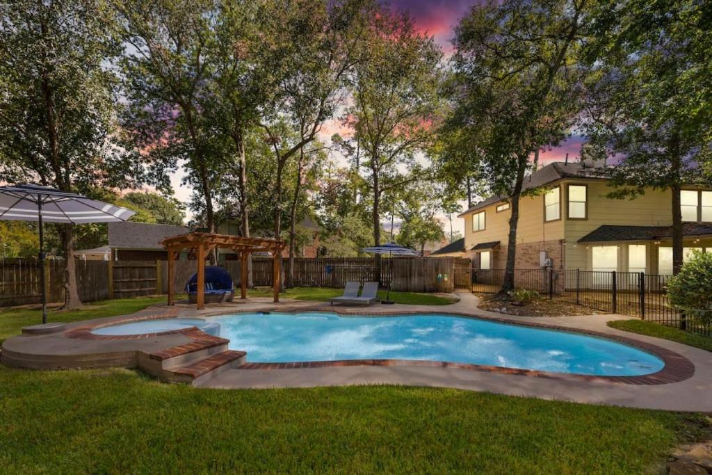 a swimming pool in a yard with a house at 5BR Train Theme Heated Pool Hot Tub EV BBQ in Spring