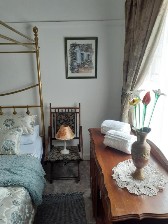 een slaapkamer met een bed en een tafel met een lamp bij 58 Boom Street Holiday Home. in Parys