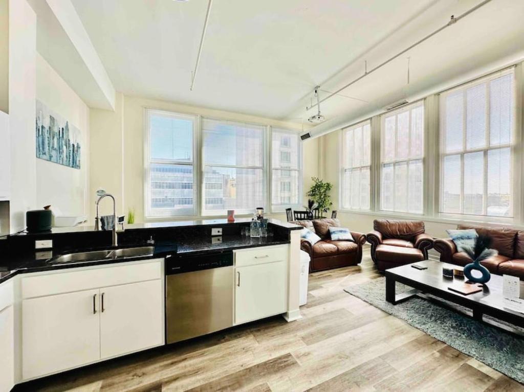 a kitchen and living room with a lot of windows at Downtown Penthouse Suite with Amazing View in Indianapolis