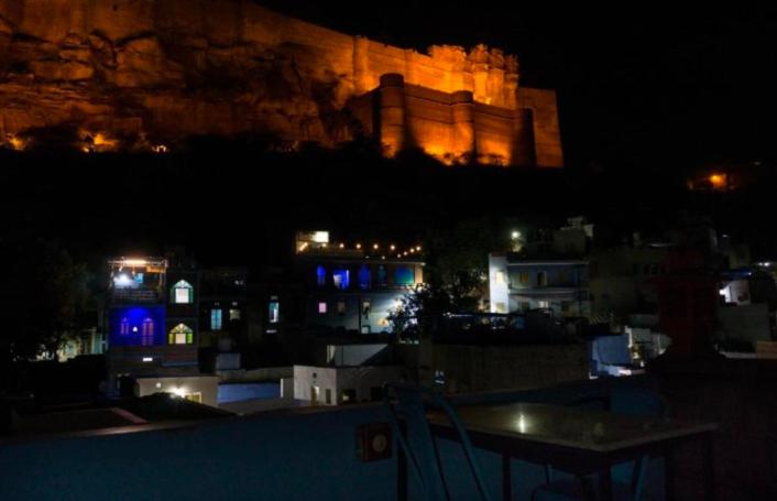 a view of a castle at night with a table at Banasa Heritage Haveli in Jodhpur