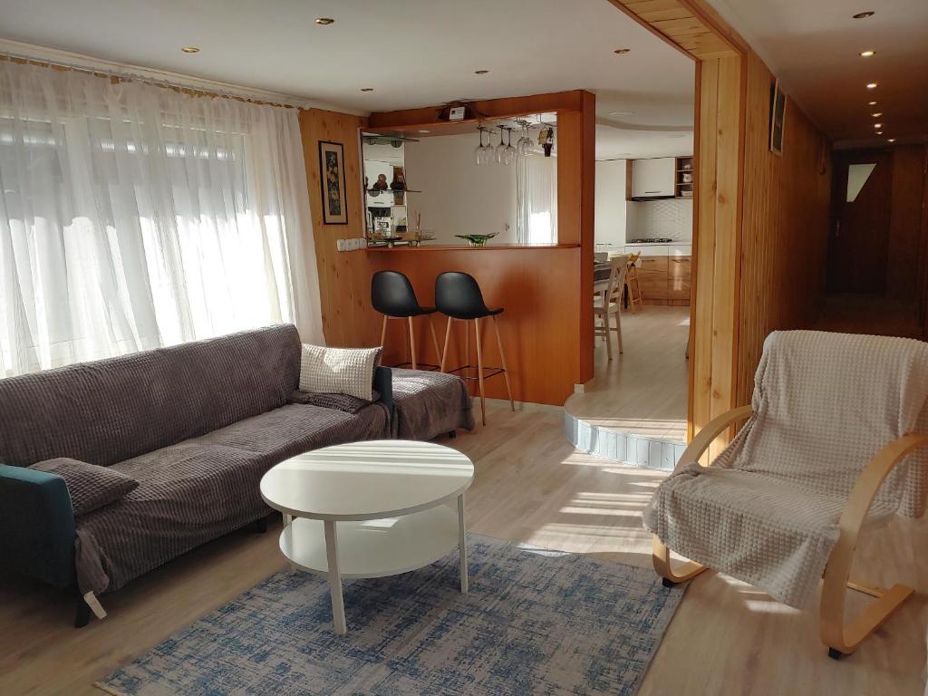 a living room with a couch and a table at Woodland Apartment in Buşteni