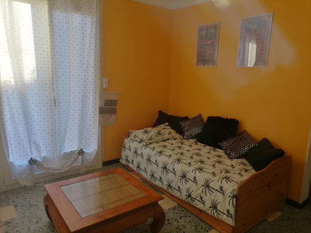 a living room with a couch and a window at Maison du soleil in Prades