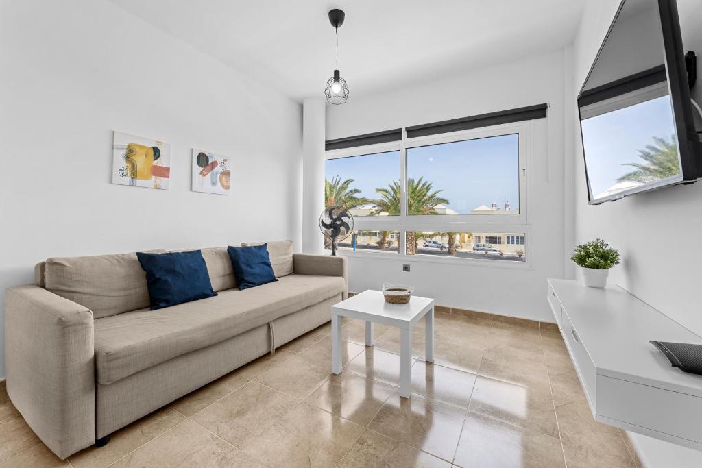 a living room with a couch and a table at Apartamento Arcoiris in Arrieta