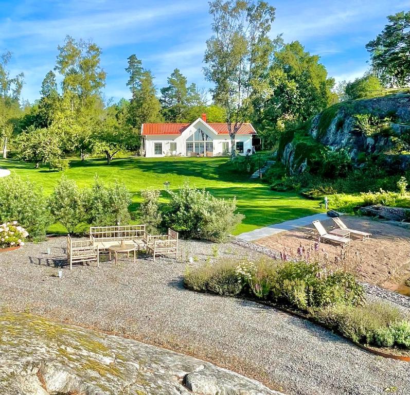 a large white house with a yard with a house at Bastuviken Bed and Breakfast in Uppsala