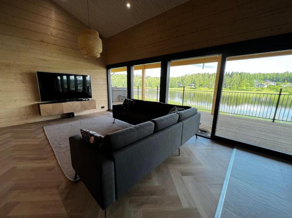 a large living room with a couch and a television at Himos Villa Golden in Jämsä