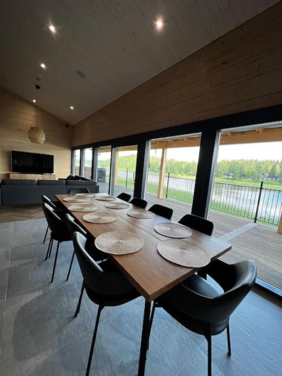 a large room with a long wooden table and chairs at Himos Villa Golden in Jämsä