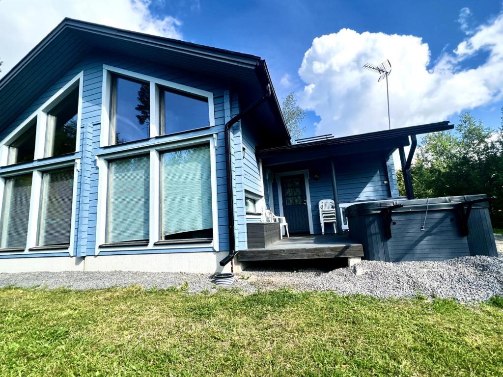 a blue house with a windmill on top of it at Himos Alahonka A in Jämsä
