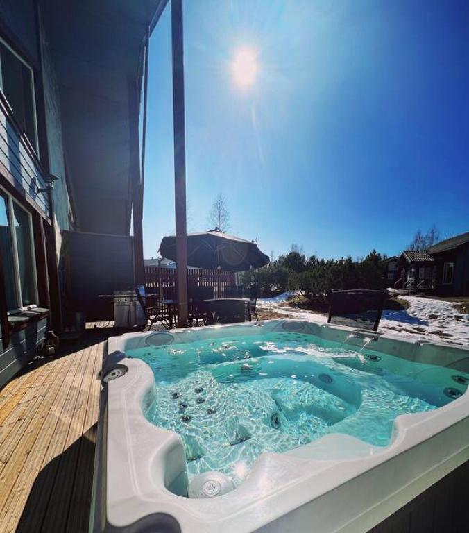 a hot tub on the deck of a house at Himoshuvi 2 in Säyrylä