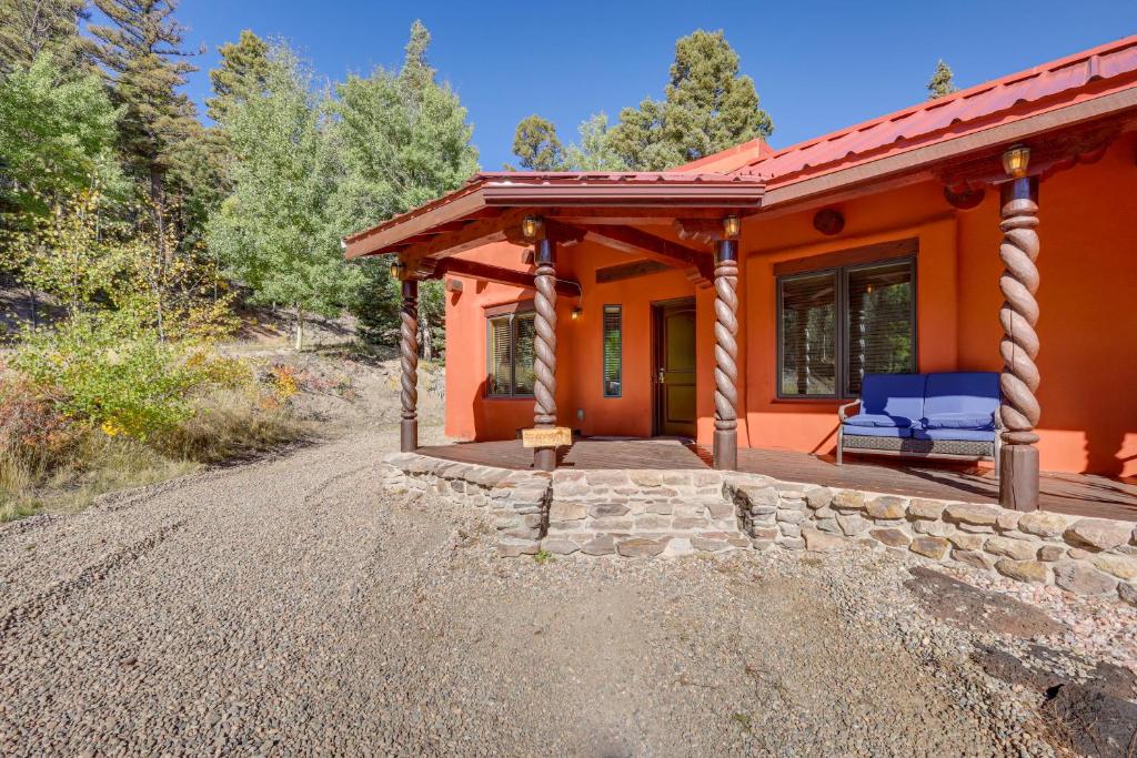 an orange house with a porch on a gravel road at Amalia Mountain Getaway with Deck, Fireplace! 