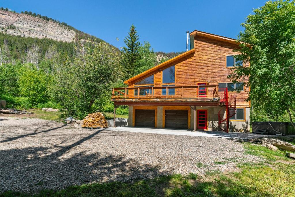 a house on a hill with a gravel driveway at Secluded Mtn home by Purg, Hot Tub, Views! Pets ok in Durango