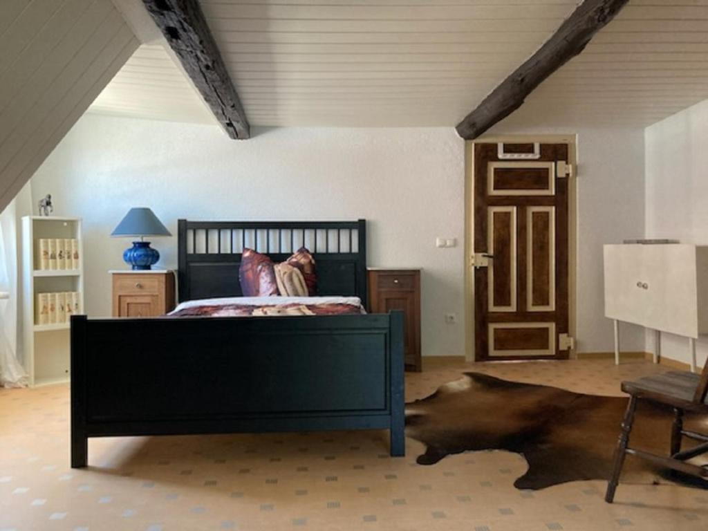 a bedroom with a bed with a black frame at Haus Buckaroo – Rancho el Rosal in Bad Mergentheim