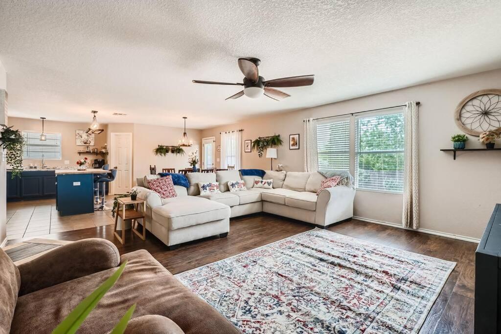 a living room with two couches and a ceiling fan at The Patriot House - Pet Friendly plus Hot Tub and Fire Pit in San Antonio