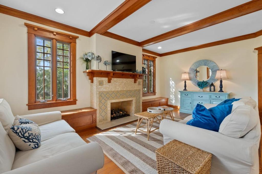 a living room with two white couches and a fireplace at Flagler Cottage - 1 Block to Historic District in Saint Augustine