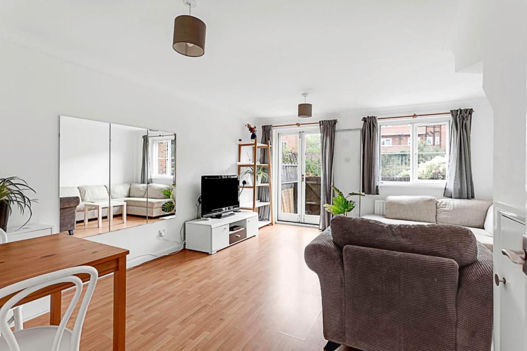 a living room with a couch and a table at Beautiful Richmond House in Richmond upon Thames